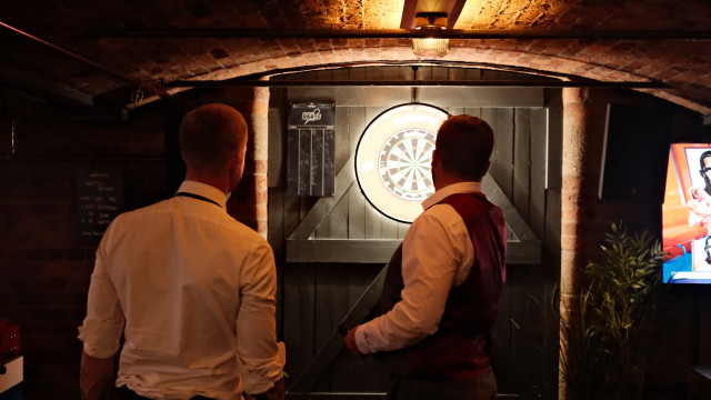 Playing darts at a wedding