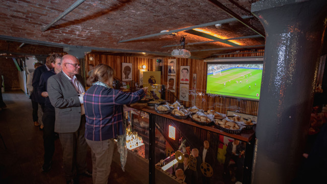 People tucking into food at corporate party